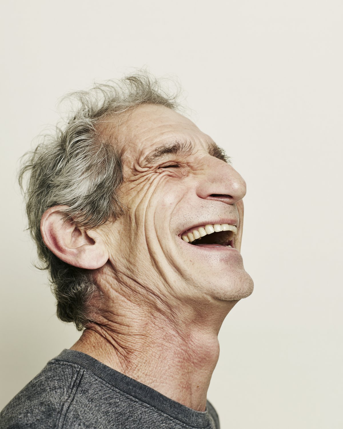 A man laughing with his head thrown back.
