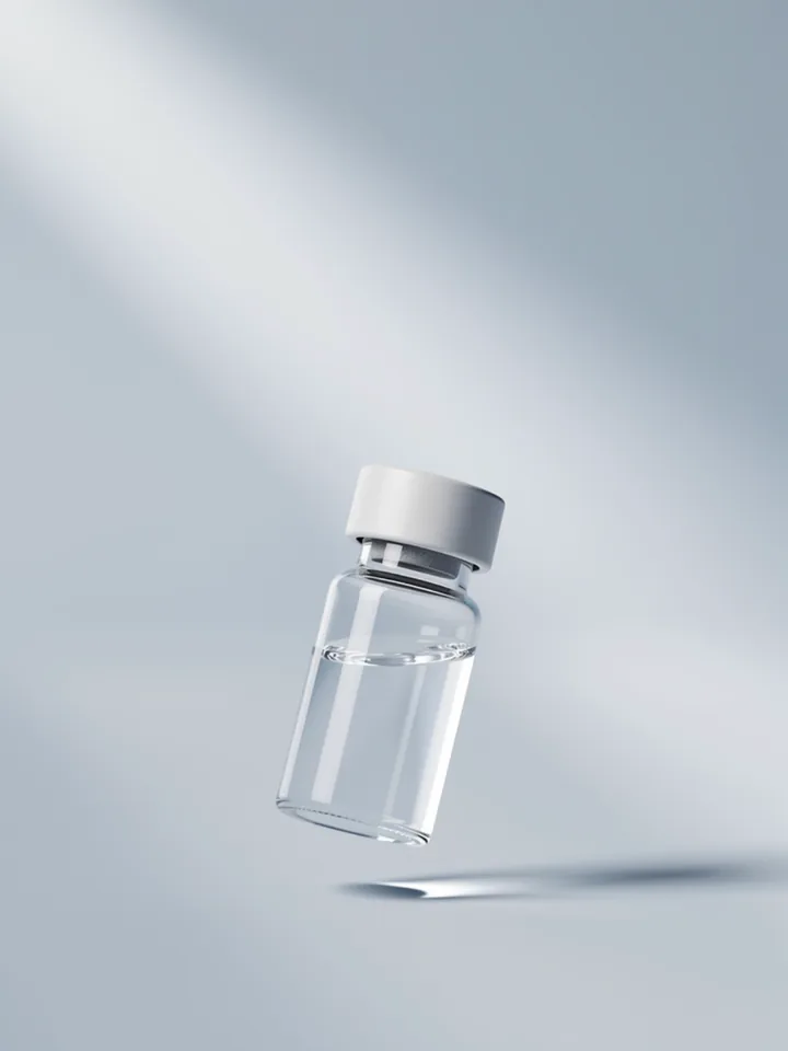 A small glass sample vial in cool light